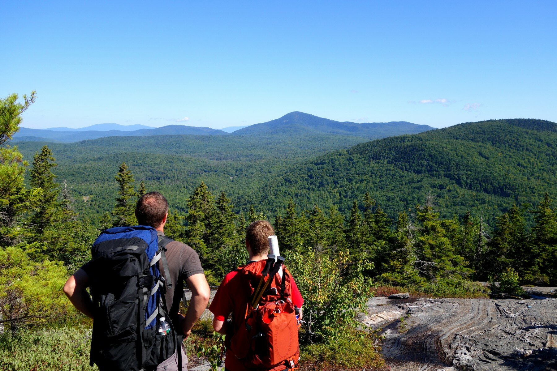 pair of hikers viewing mountains